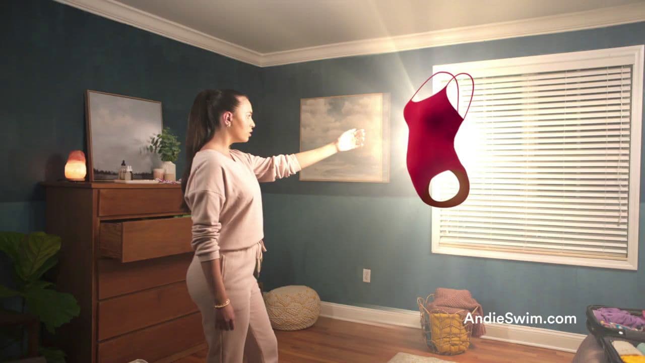 a woman holding a lamp in a room