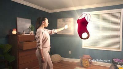 a woman holding a lamp in a room