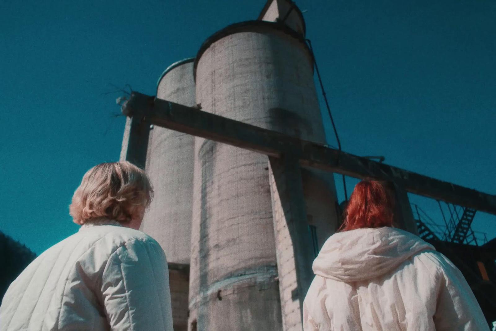 a couple of people that are standing in front of a tower