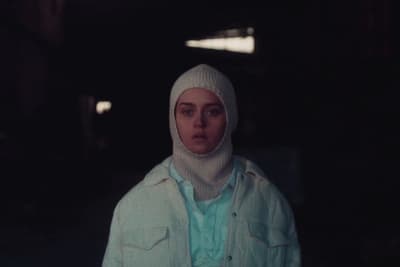 a woman in a white jacket and a white hat