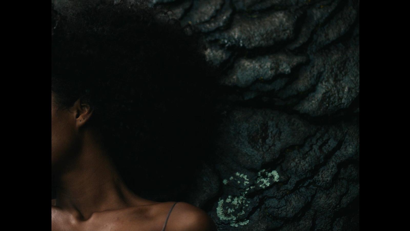 a close up of a person with an afro