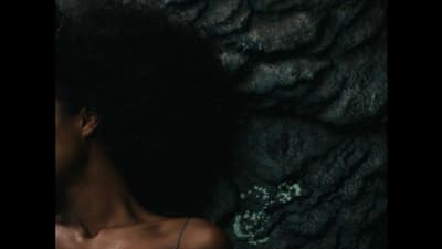 a close up of a person with an afro
