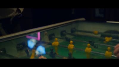 a close up of a foosball table with people playing foosball