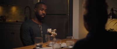 a man sitting at a table in a dark room