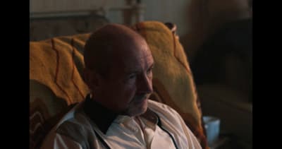 a bald man in a white shirt and tie