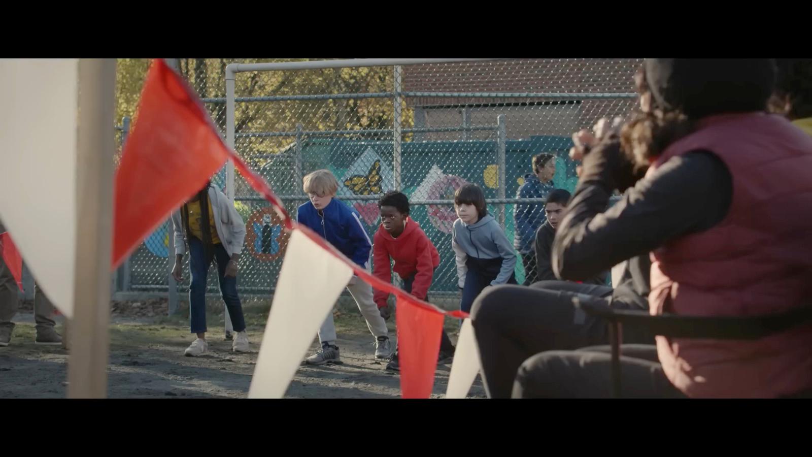 a group of people standing next to each other near a fence