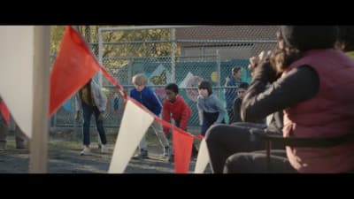 a group of people standing next to each other near a fence