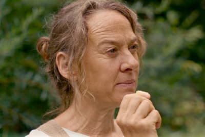 a woman holding a piece of food in her hand