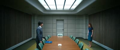 a man and a woman standing in a conference room