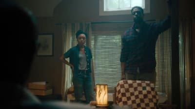 a man standing next to a woman in a living room