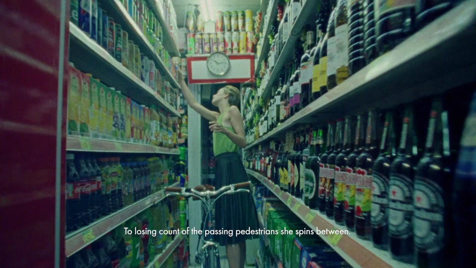 a woman is standing in a grocery store aisle