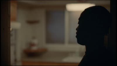 a silhouette of a person in a dark room