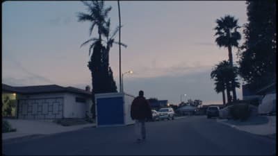 a person walking down a street at dusk
