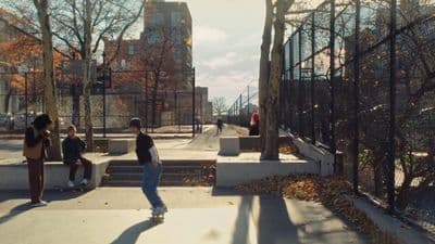 a group of people standing around a skateboard park