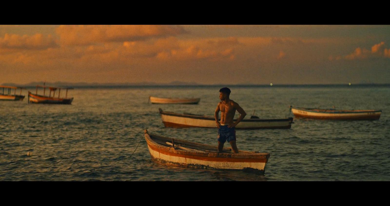 a man standing on a boat in the water