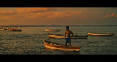 a man standing on a boat in the water