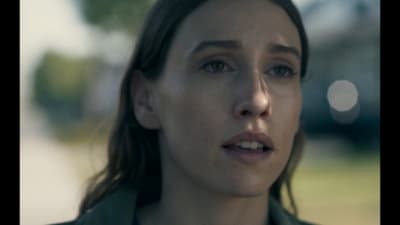 a close up of a person wearing a green jacket