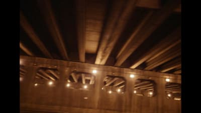 a view of the underside of a bridge at night