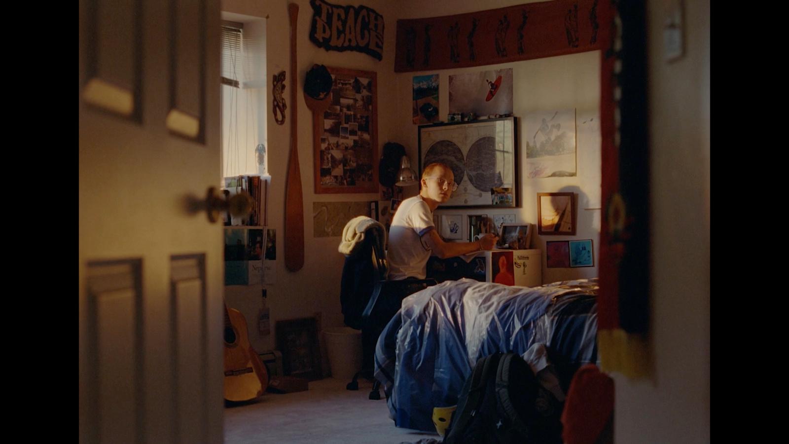 a person sitting on a bed in a room