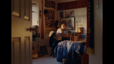 a person sitting on a bed in a room