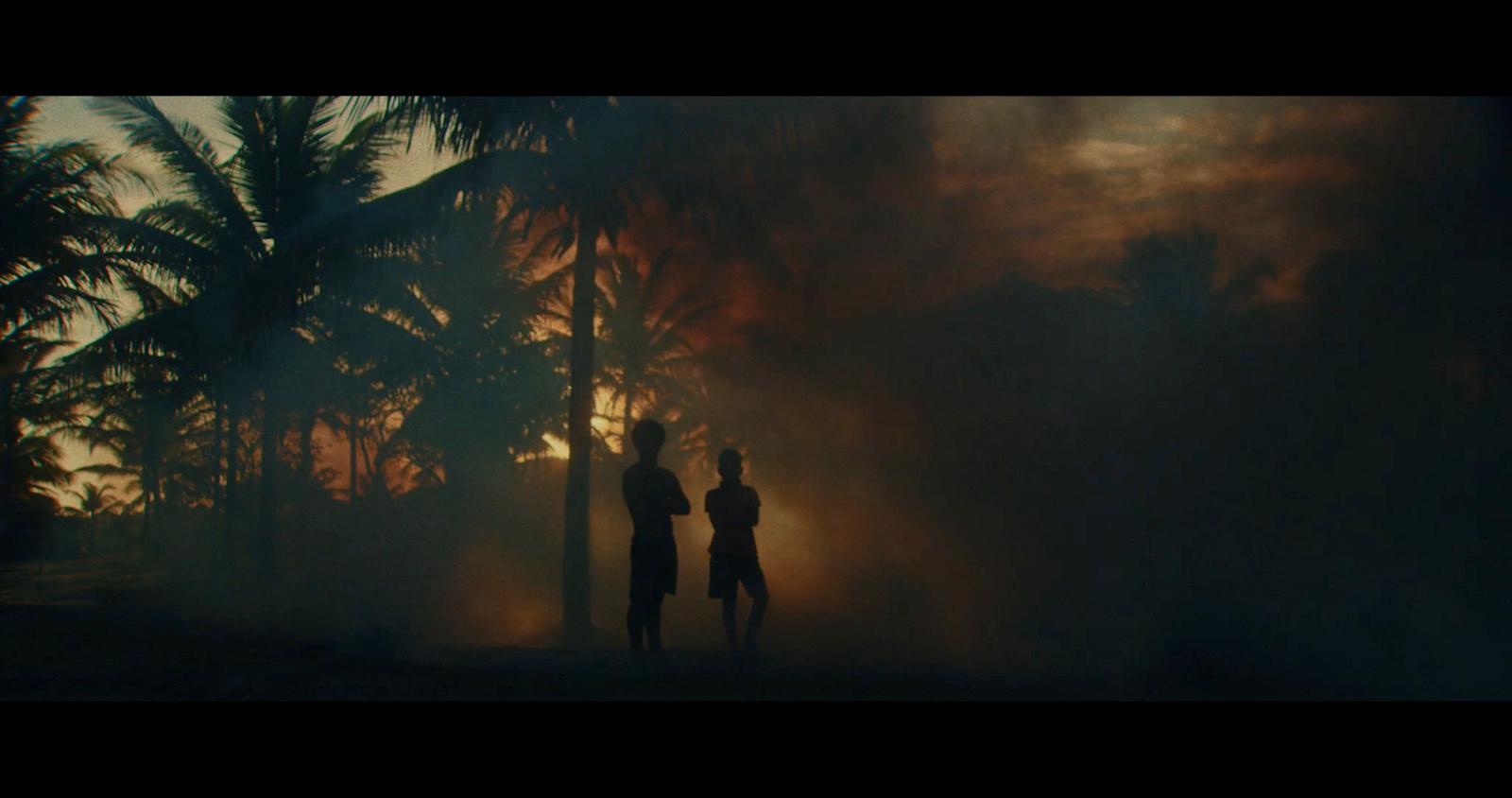 a couple of people that are standing in the dark