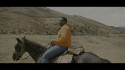 a man riding on the back of a brown horse
