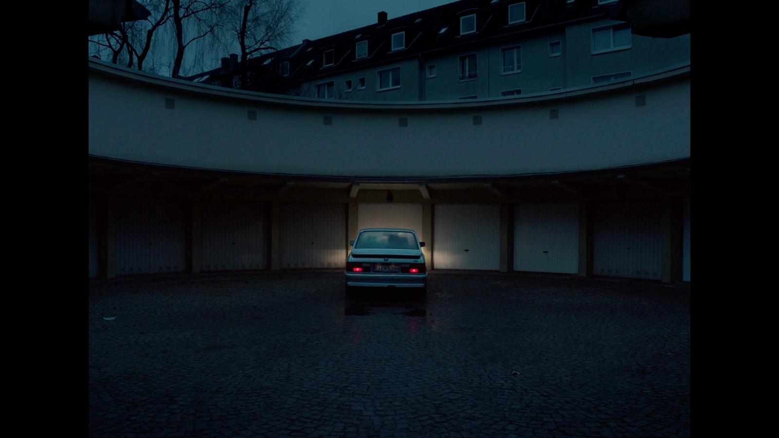 a car parked in a parking garage at night