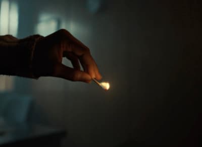 a person holding a lit match in their hand