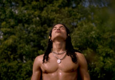 a shirtless man with long hair and no shirt on