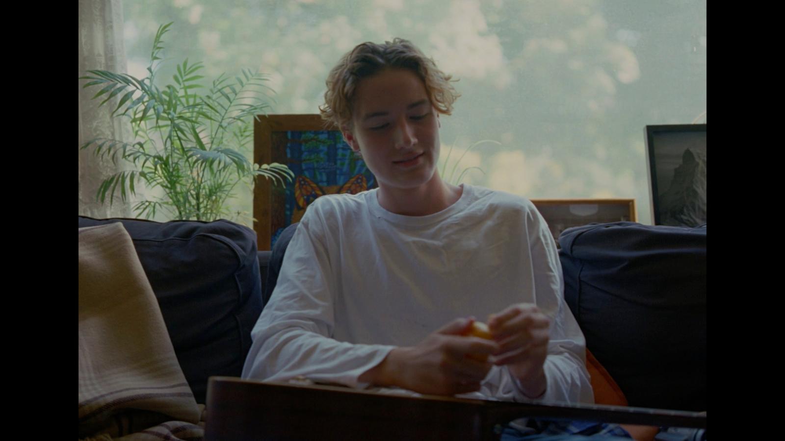 a person sitting on a couch with a laptop