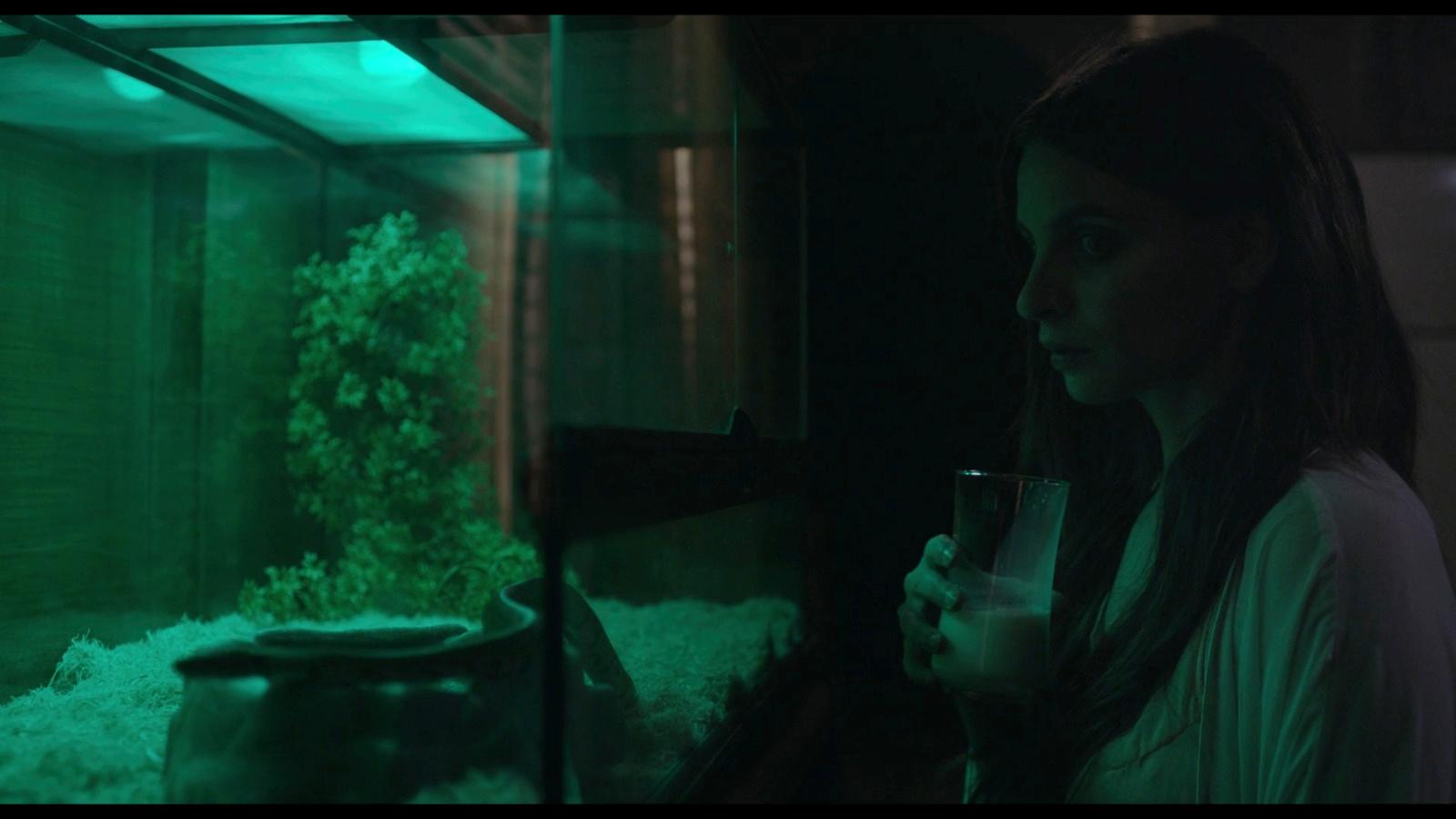 a woman standing in front of a fish tank