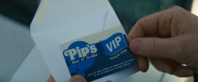 a person holding a white envelope with a blue and white sticker on it