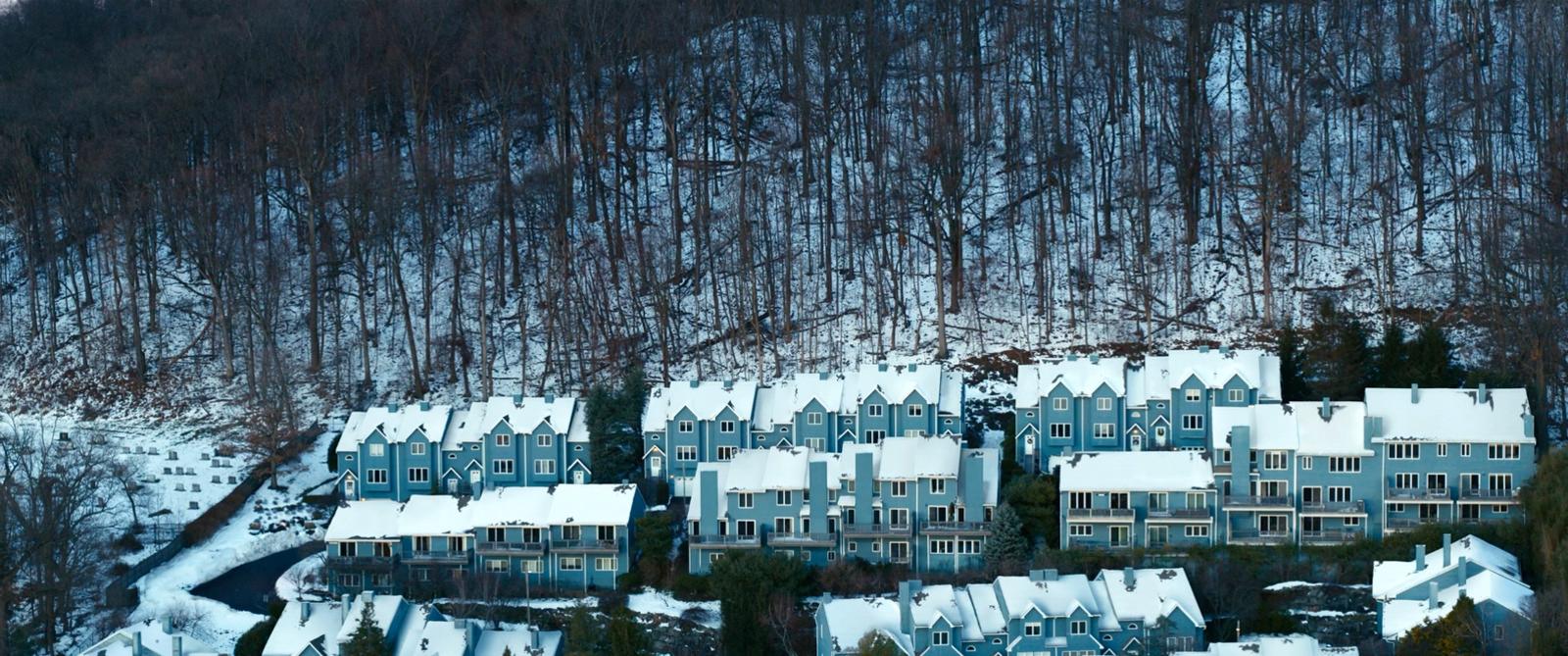 a large group of houses covered in snow
