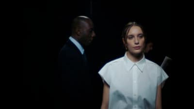 a woman in a white shirt and a man in a black suit