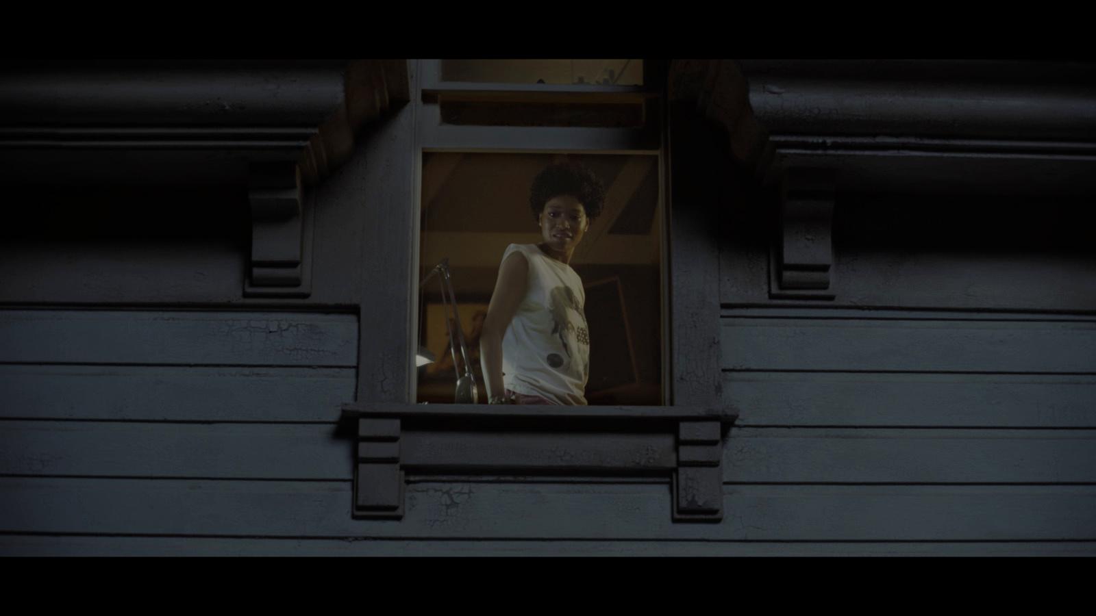 a man standing in a window of a building