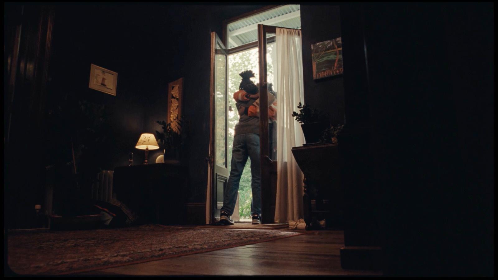 a man standing in the doorway of a house