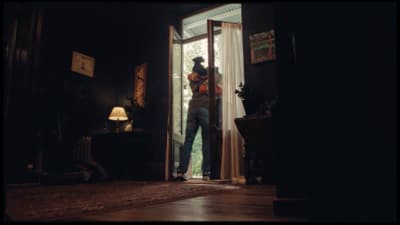 a man standing in the doorway of a house
