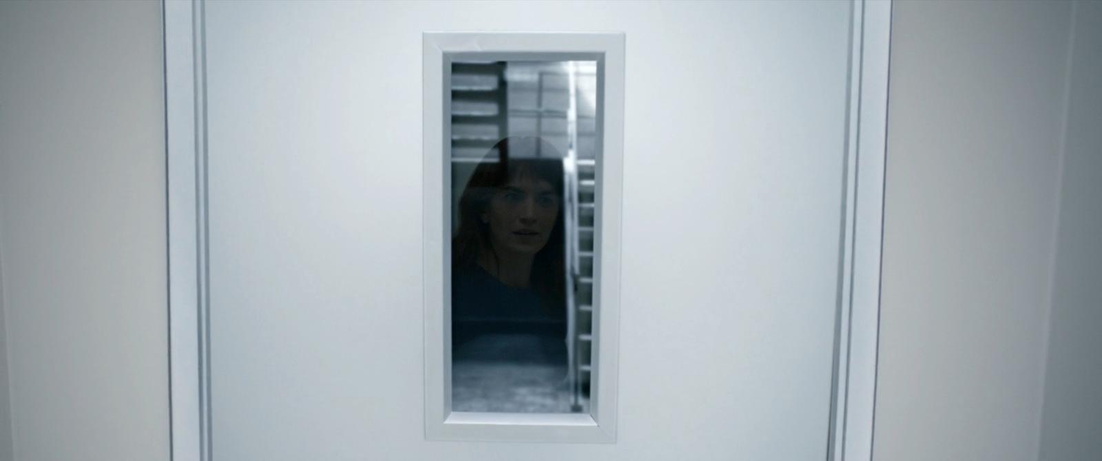 a woman standing in front of a white door