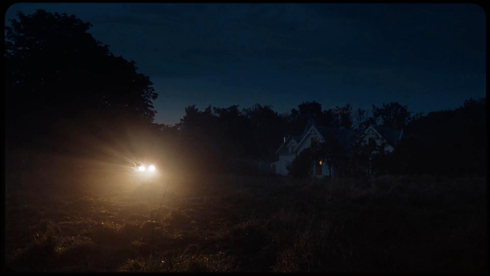 a car driving down a road at night
