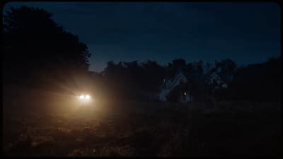 a car driving down a road at night
