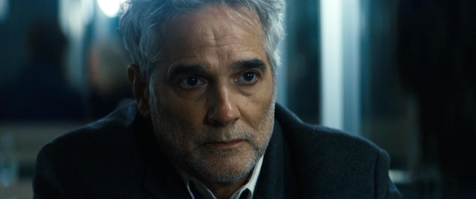 a man with grey hair wearing a black jacket