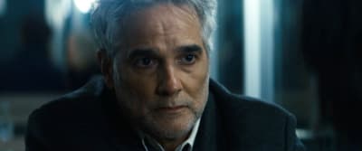 a man with grey hair wearing a black jacket