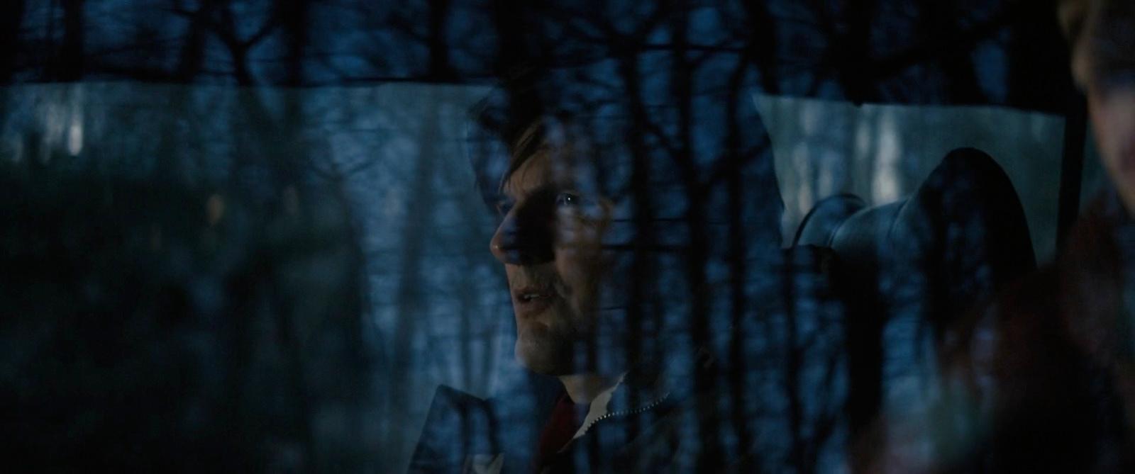 a man standing in front of a mirror in a forest