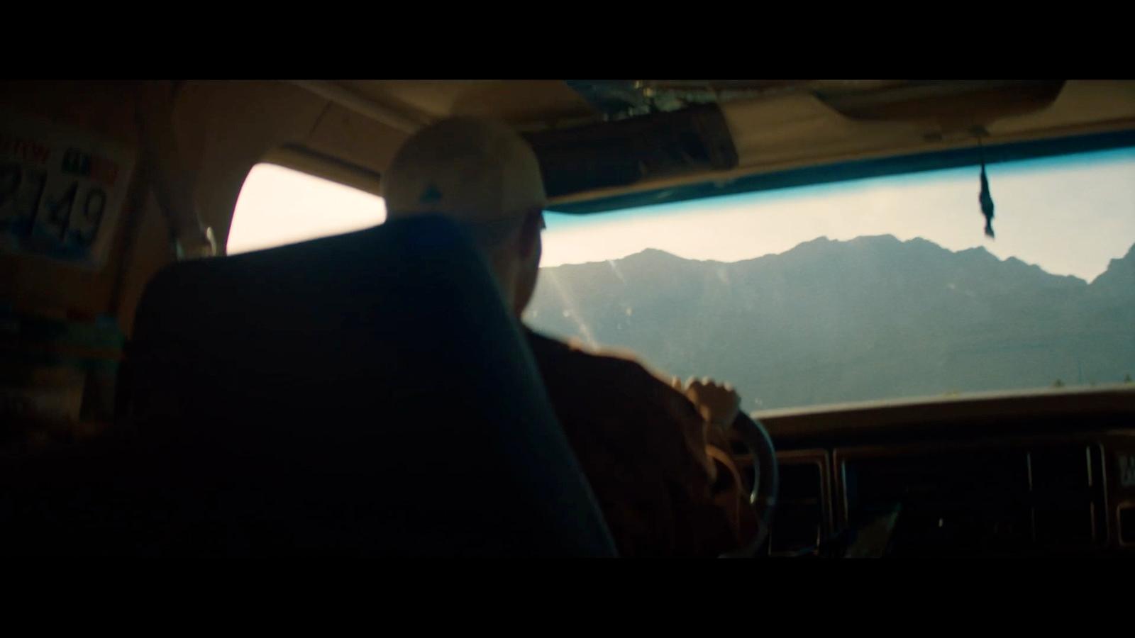 a man sitting in the back of a bus looking out the window