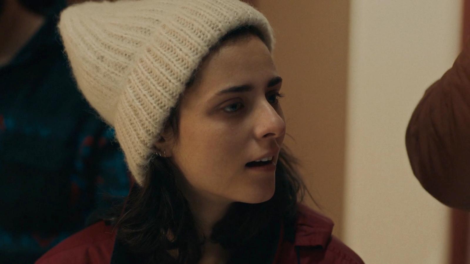a woman wearing a white hat in a room