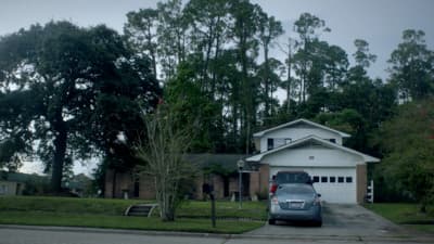 a car is parked in front of a house