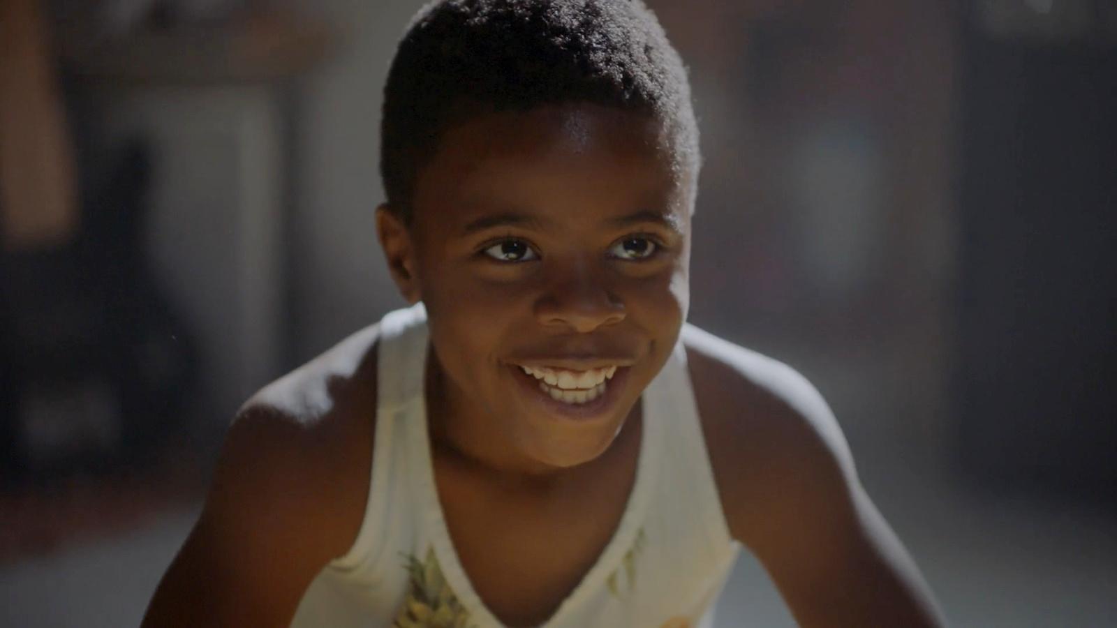 a young boy with a smile on his face