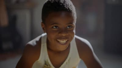 a young boy with a smile on his face