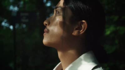 a man in a suit and tie looking away from the camera