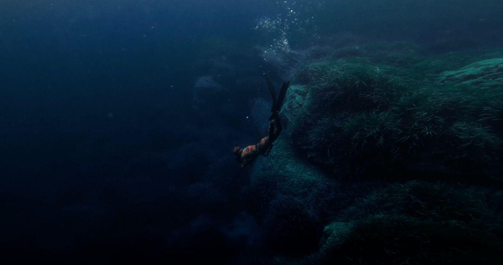 a person swimming in the ocean with a large amount of water